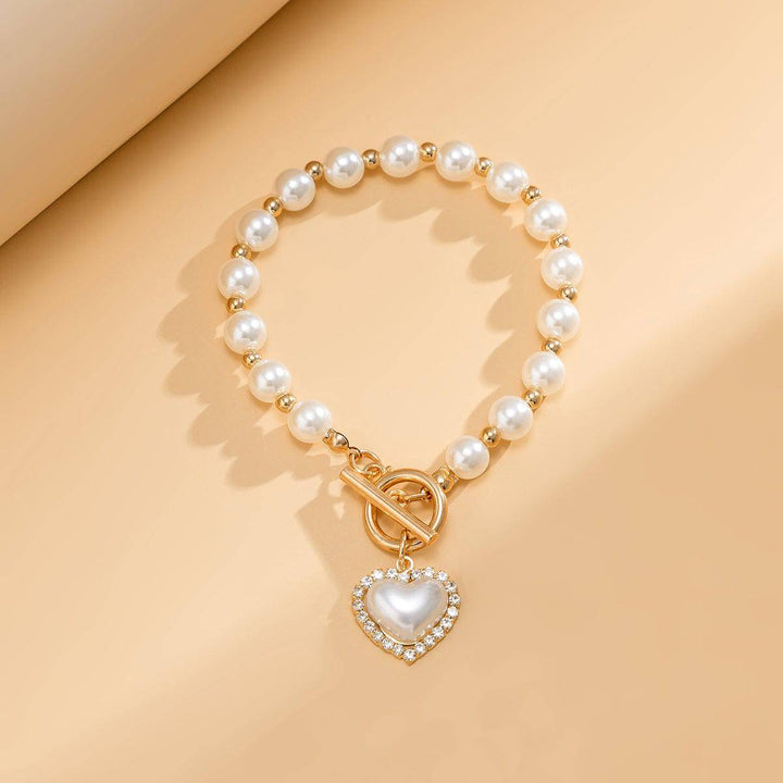 CALORA_ Elegante Zoetwaterparel Armband met Gouden Accenten