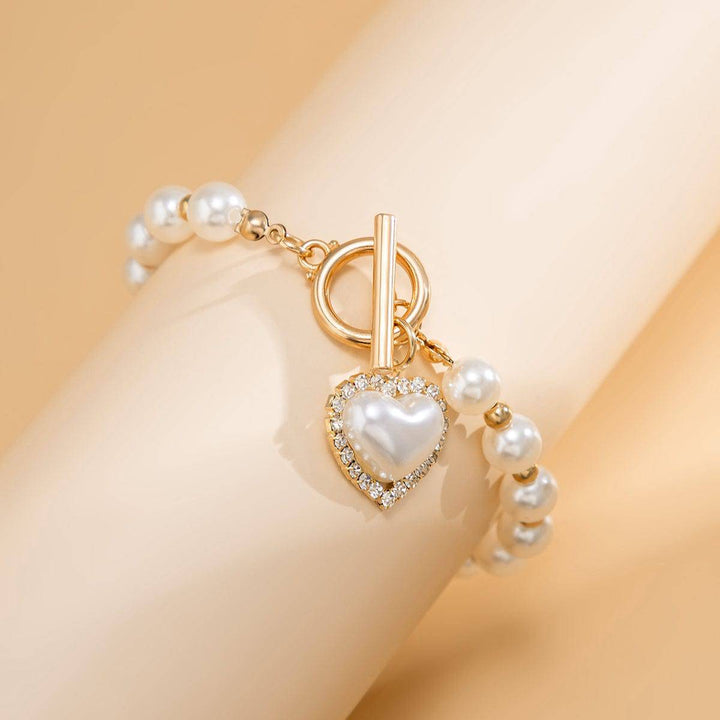 CALORA_ Elegante Zoetwaterparel Armband met Gouden Accenten
