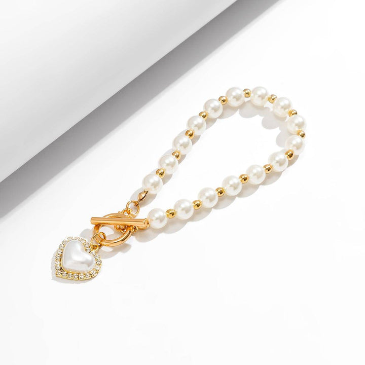 CALORA_ Elegante Zoetwaterparel Armband met Gouden Accenten
